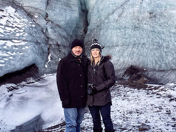 Photo of us standing in front of a glacier in Iceland