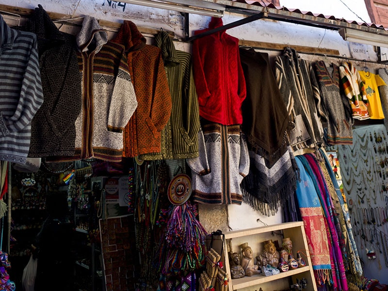 Alpaca sweaters hanging in a shop in Cusco Peru