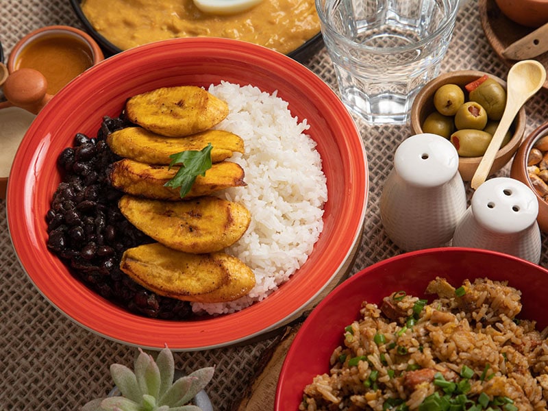 Traditional Peruvian food with rice, potatoes, and black beans