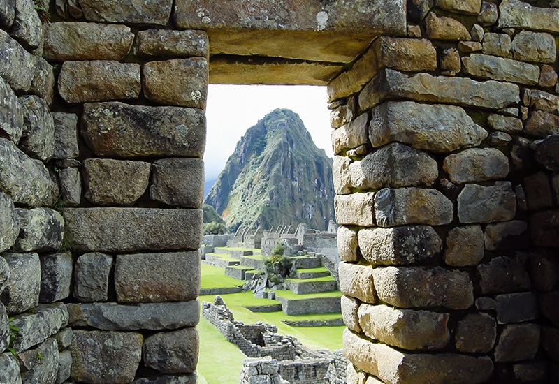 The main gate of Machu Picchu frames Huayna Picchu Mountain